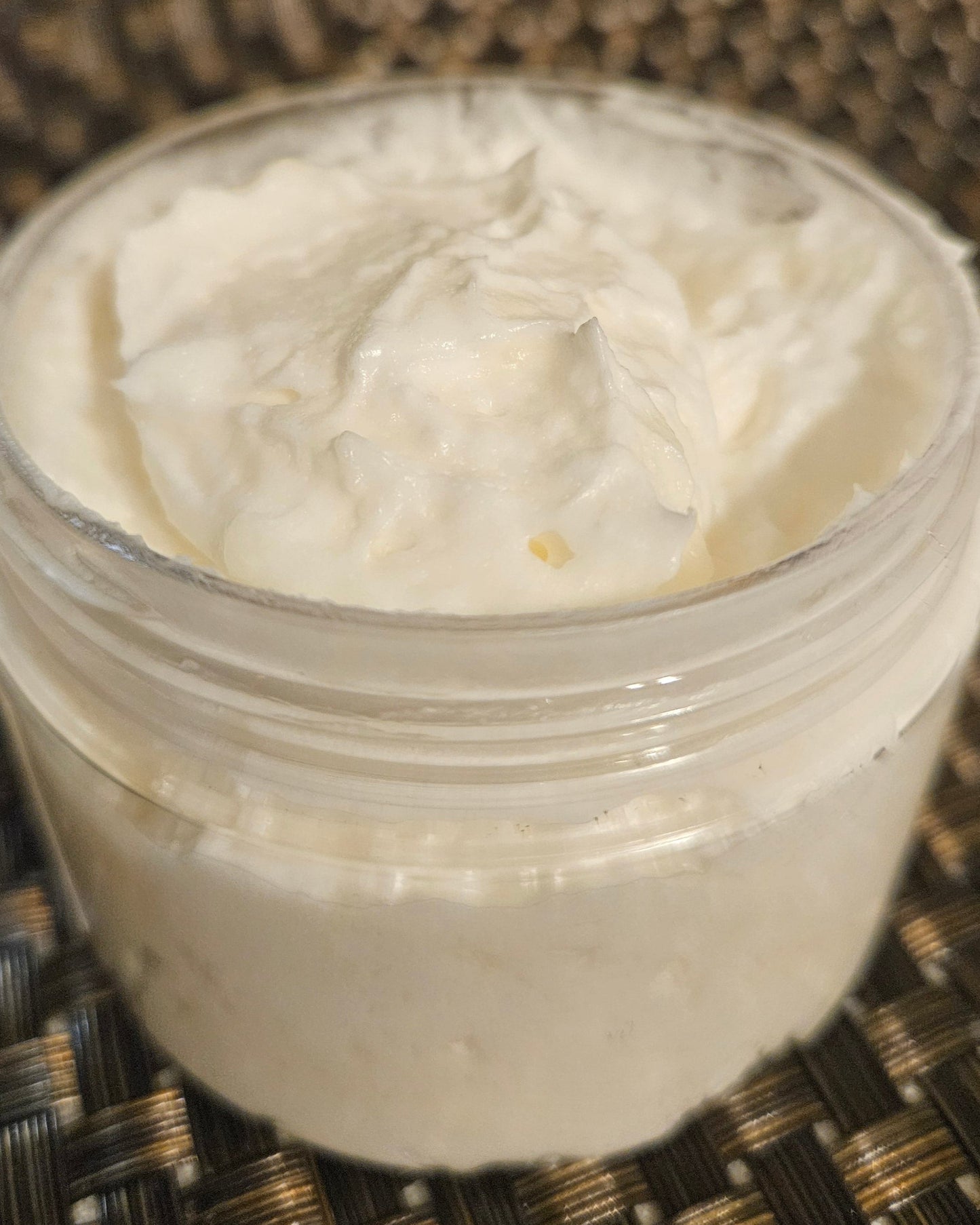 Whipped shea butter with top off and no label to see how creamy it is